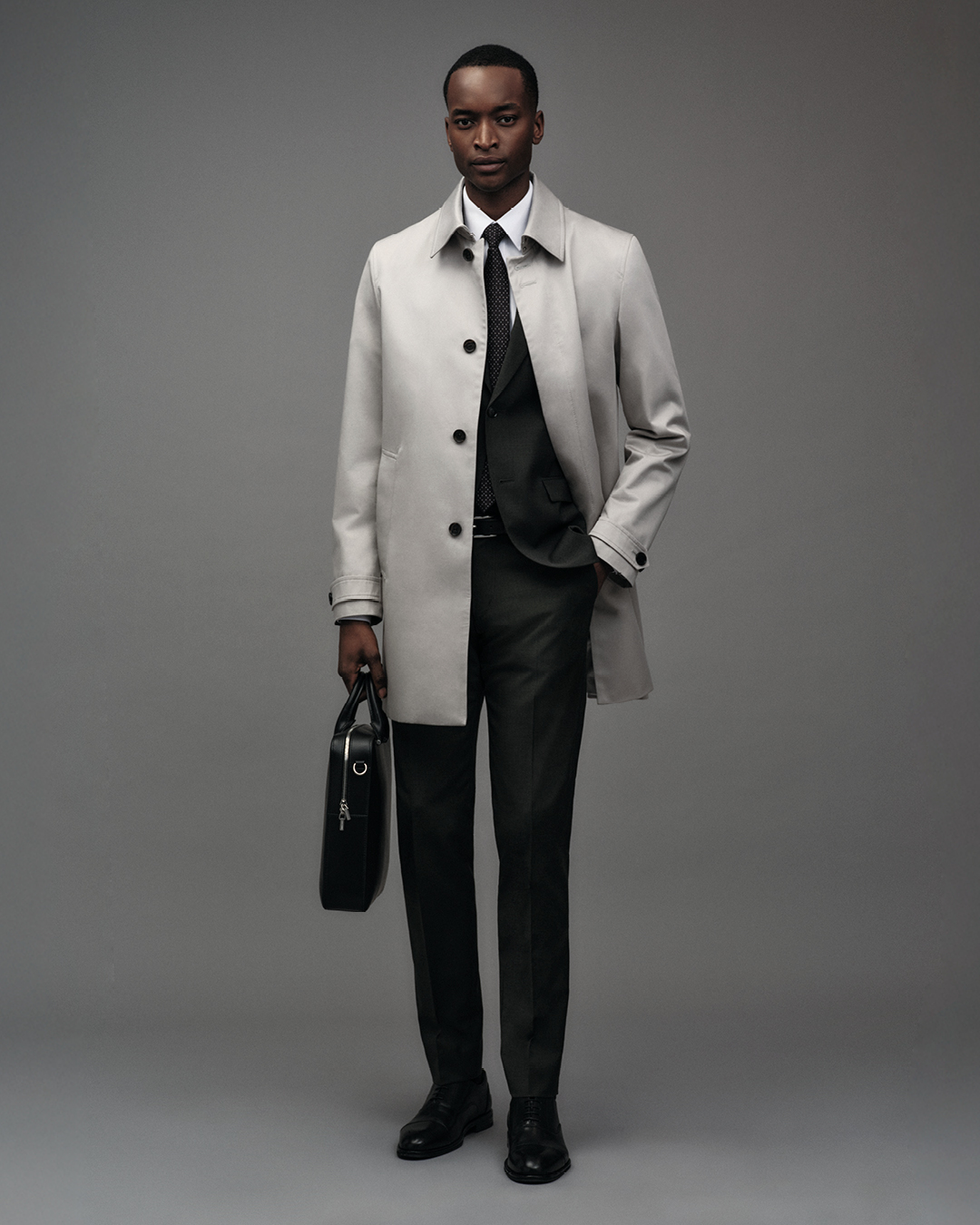 Man in grey car coat and briefcase